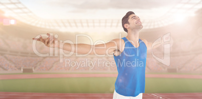 Excited male athlete with arms outstretched