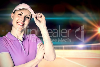 Sportswoman posing with touching cap