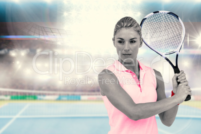 Composite image of sportswoman posing with a tennis racket