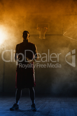 Portrait of a basketball player holding a ball in his hands