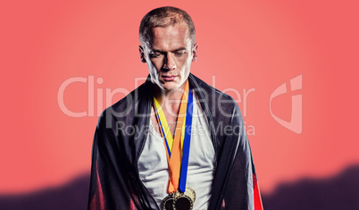 Composite image of athlete with german flag wrapped around his b