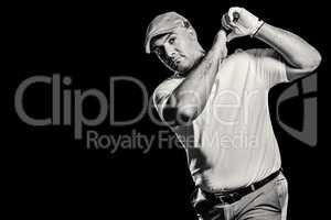 Portrait of golf player taking a shot