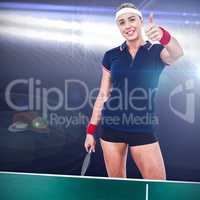 Composite image of female athlete posing with ping pong racket a