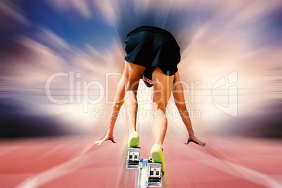 Composite image of sportsman on starting blocks