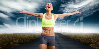 Composite image of fit woman celebrating victory with arms stret