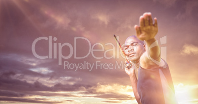 Composite image of portrait of sportsman practising a javelin th
