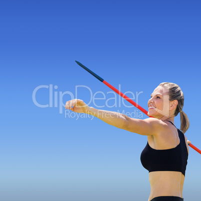 Portrait of happy sportswoman is practising javelin throw