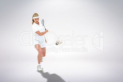 Composite image of badminton player playing badminton