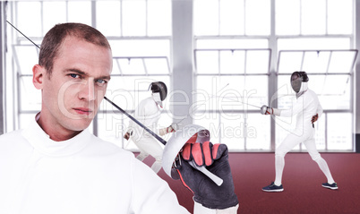 Composite image of close-up of swordsman holding fencing sword