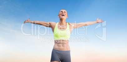 Composite image of fit woman celebrating victory with arms stret