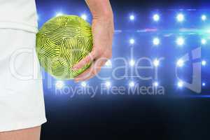 Composite image of sportswoman holding a ball