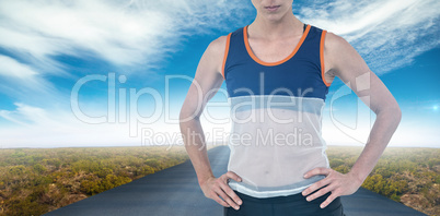 Composite image of female athlete standing with hand on hip