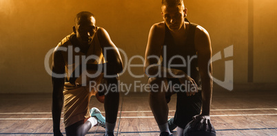 Portrait basketball players posing on their knees