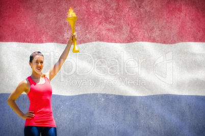 Composite image of sporty woman posing and smiling with olympic