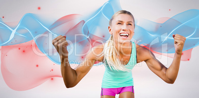 Composite image of portrait of sportswoman smiling and raising a