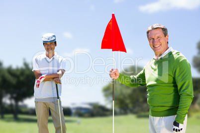 Composite image of men holding a golf club