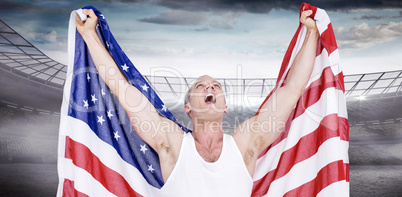 Composite image of athlete posing with american flag after victo