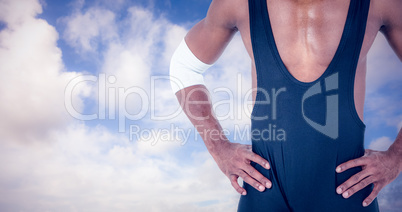 Composite image of athlete standing with hands on hip