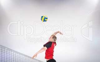 Composite image of sportsman hitting volleyball