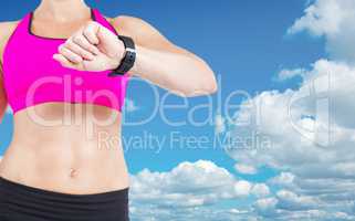 Composite image of female athlete watching her smart watch