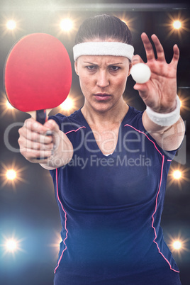 Composite image of female athlete holding table tennis paddle an