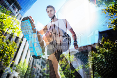 Composite image of handsome athlete running in the street