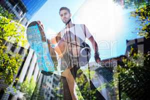 Composite image of handsome athlete running in the street