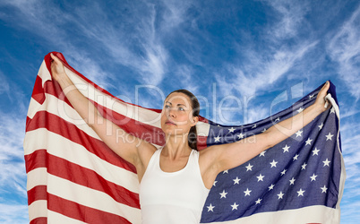 Composite image of female athlete posing with american flag