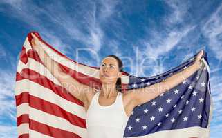 Composite image of female athlete posing with american flag