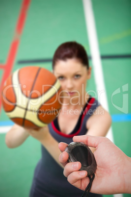 Composite image of close up of coach is holding a stopwatch