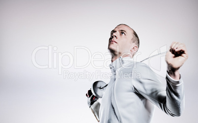 Composite image of swordsman holding fencing sword