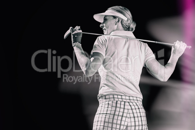 Composite image of woman playing golf