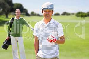 Composite image of golfing friends smiling at camera