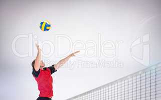 Composite image of sportsman hitting volleyball