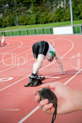 Composite image of close up of coach is holding a stopwatch