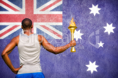 Composite image of rear view of sportsman holding a cup