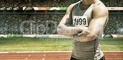 Composite image of handsome sportsman is posing with crossed arm