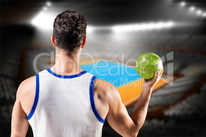 Composite image of rear view of male athlete holding ball