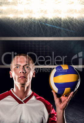 Composite image of sportsman holding a volleyball