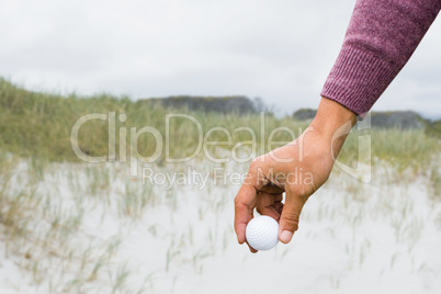View of hand with golfball