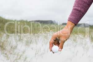 View of hand with golfball