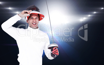 Composite image of man wearing fencing suit practicing with swor