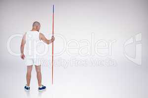 Composite image of athlete standing with javelin