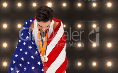 Composite image of athlete with gold medals and american flag lo