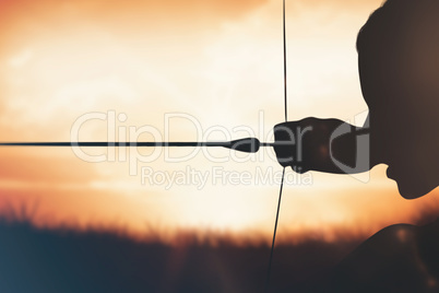 Composite image of close up of sportswoman practising archery on Composite image of close up of sportswoman practising archery on