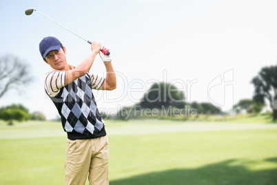 Man playing golf against nature scene