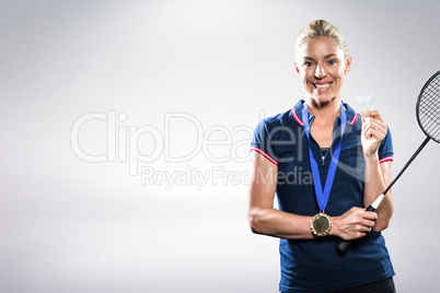 Composite image of badminton player posing with gold medal aroun