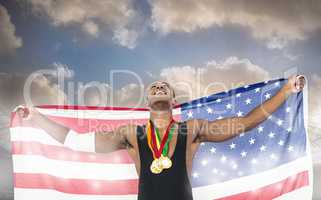 Composite image of athlete holding gold medals and american flag