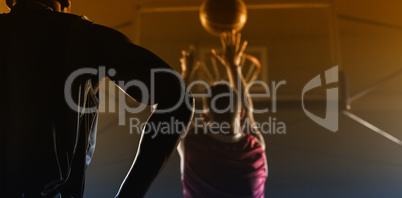 Rear view of a player shooting a basketball