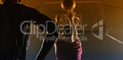 Rear view of a player shooting a basketball